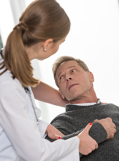 Doctor examining an adult’s shoulder and discussing ongoing symptoms at Mambourin Doctors.